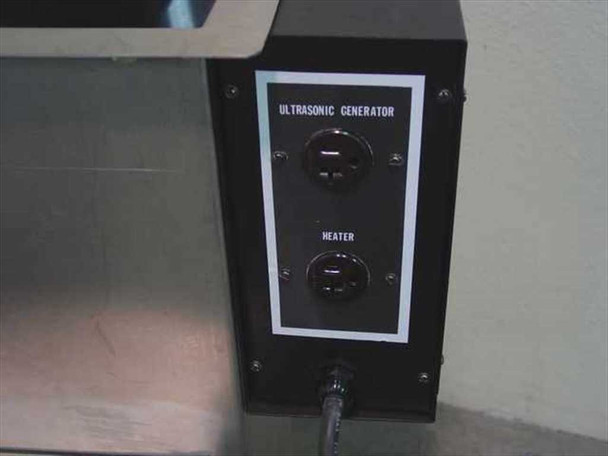 Photosonic ultrasonic tank control panel close-up — black panel showing Ultrasonic Generator and Heater outlet receptacles on side of stainless tank