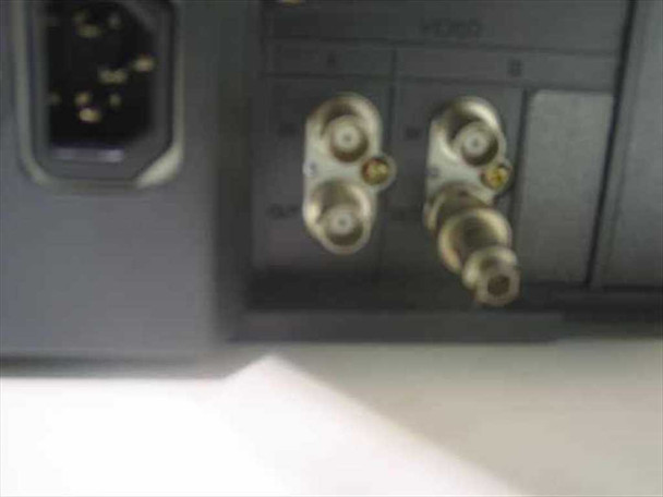 Philips LTC2813/60 rear panel close-up showing IEC AC power inlet and four BNC video connectors (two pairs for dual A/B inputs with loop-through)