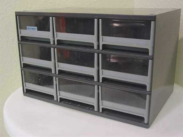 Bretford grey steel cabinet front view showing 9 plastic drawers in 3x3 configuration with small asset tag on upper-left drawer