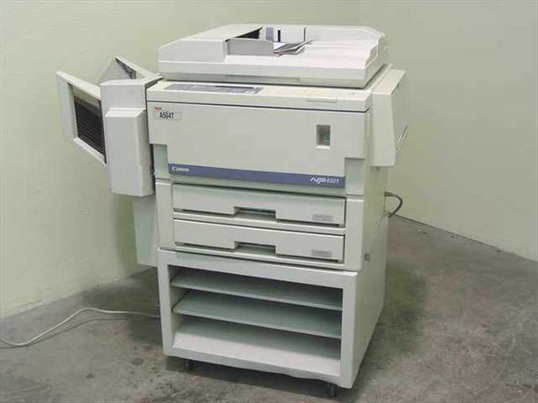 Canon NP6221 analog copier front-left view showing ADF on top, two paper drawers, and open-shelf pedestal stand