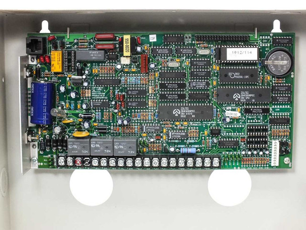 Digital Monitoring Products 1912 Command Processor – close-up of PCB circuit board inside enclosure showing ICs, relays, and terminal blocks
