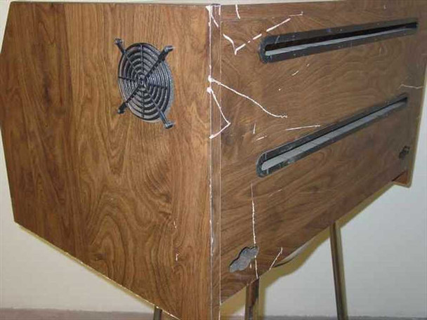 Dot matrix printer sound enclosure – right side view showing fan ventilation grille, paper feed slot, and edge delamination with peeling laminate