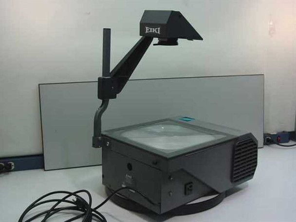 Eiki 3990 BP overhead projector left-side view – folding arm extended, power cord visible on table