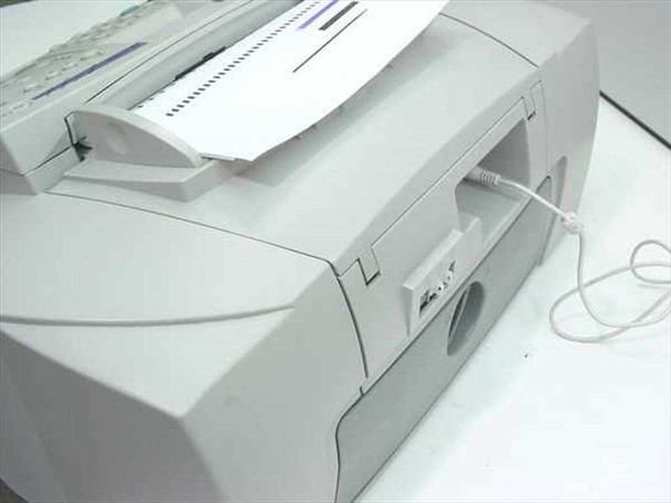 HP OfficeJet K80xi right-side and rear view showing ADF paper tray loaded with documents and power cable
