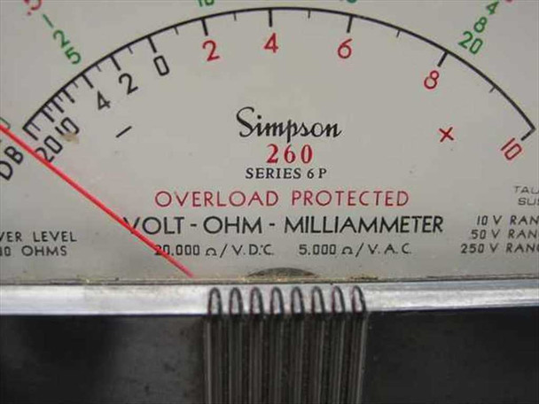 Simpson 260 Series 6P dial detail — 'SERIES 6P / OVERLOAD PROTECTED / VOLT-OHM-MILLIAMMETER / 20,000 Ω/V DC  5,000 Ω/V AC' printed below scale arc; taut-band suspension noted; voltage range correction table visible at right