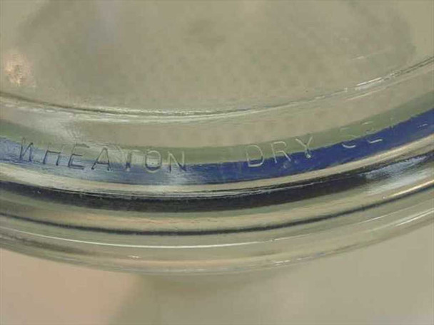 Close-up of Wheaton Dry Seal embossed text on glass rim of desiccator bowl with blue rubber gasket seal visible