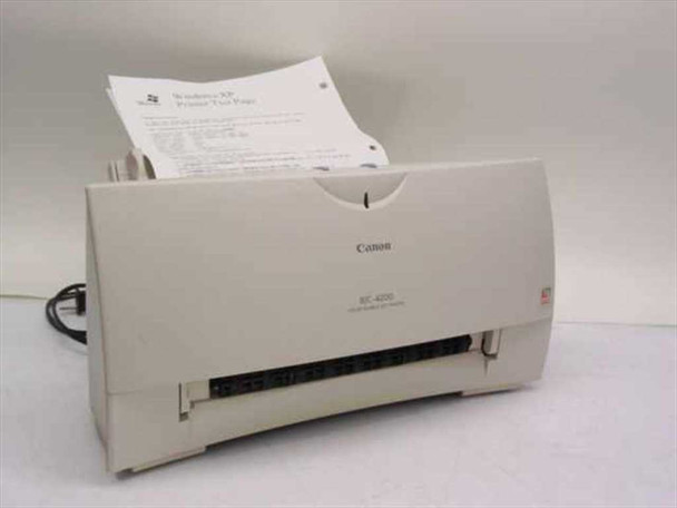 Canon BJC-4200 Color Bubble Jet Printer front view with paper loaded in input tray and Windows XP test page in output tray