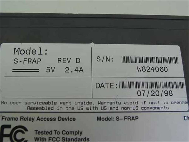 Sync S-FRAP bottom label showing Model S-FRAP Rev D, 5V 2.4A power rating, serial number W824060, date 07/20/98, Frame Relay Access Device designation, and FCC compliance marking