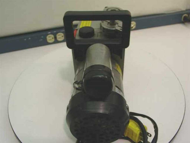 Edwards E2M-1 vacuum pump — rear end-on view showing motor end cap, carry handle, and warning label