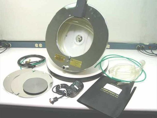 Headway Research CB15 photo resist spinner complete kit — motor/bowl assembly, two chuck disks, foot switch, green and clear tubing, and instruction manual binder laid out on workbench