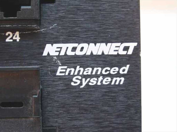 Close-up of AMP NetConnect Enhanced System label on the patch panel front face showing product line branding and minor surface scratching