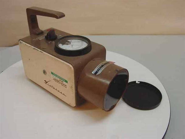 Victoreen Model 440 survey meter – three-quarter front view showing brown housing, analog meter dial, rotary range selector knob, and circular end-window detector with black cap fitted