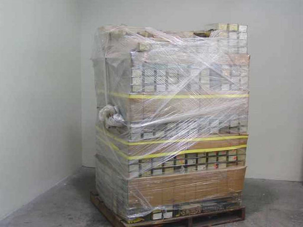 Second pallet of wrapped vintage film camera parts from side angle — multiple shelf layers visible