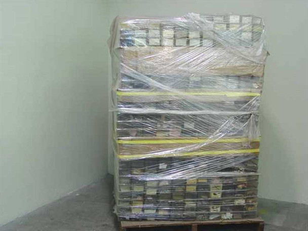 Large pallet of vintage film camera repair parts wrapped in plastic shrink wrap — full pallet side view