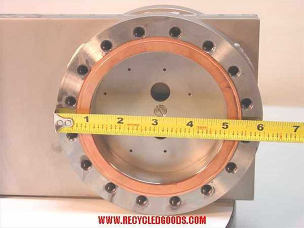 VAT Series 108 UHV gate valve — close-up of flange face with tape measure showing approximately 6.5–7 inches total flange OD; copper gasket groove, bolt pattern, and center bore visible