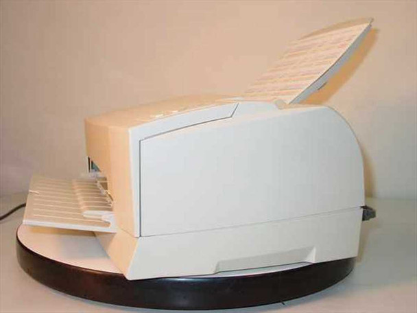 Epson Stylus Color 800 left-side view – cream housing, paper loaded, output tray extended, sitting on dark round base