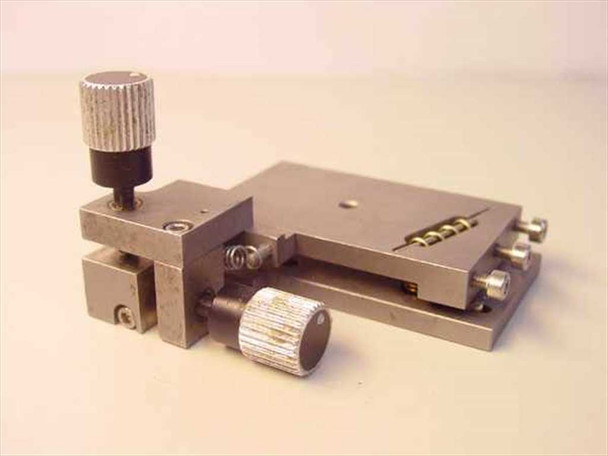 Newport 561-Tilt ULTRAlign fiber optic tilt rotation stage – three-quarter front-left view showing knurled adjustment knobs, spring-return tilt clamp mechanism, and side mounting screws