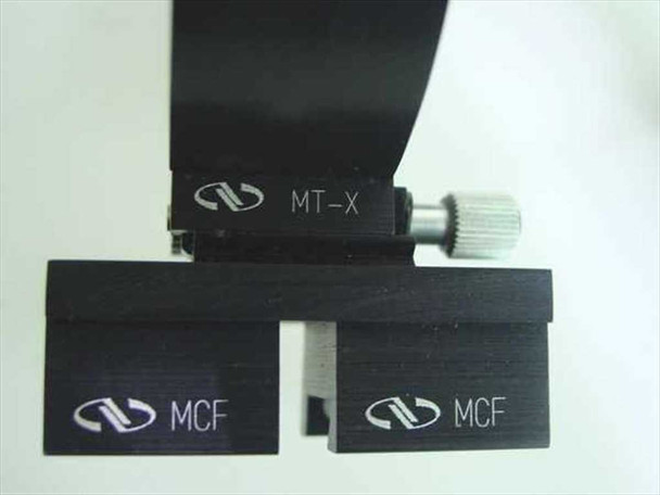Newport MT-X adjustable holder with thumbscrew and two Newport MCF clamp forks laid flat, showing Newport logo on each component