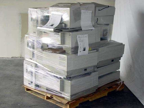 Tektronix Phaser color printer bulk pallet — side view showing full pallet height with multiple units stretch-wrapped and paper documentation attached