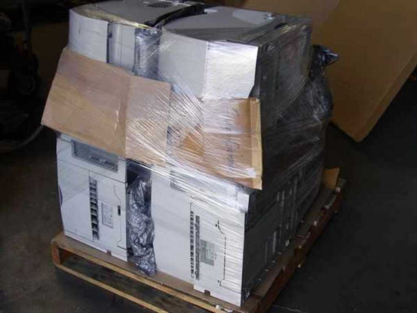 Lexmark Optra printer lot palletized and partially wrapped in plastic stretch wrap with cardboard protection — indoor warehouse view
