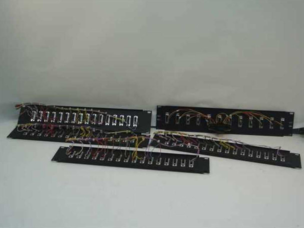 Lot of 4 black rackmount DB25 serial patch panels with wiring harnesses, overhead view