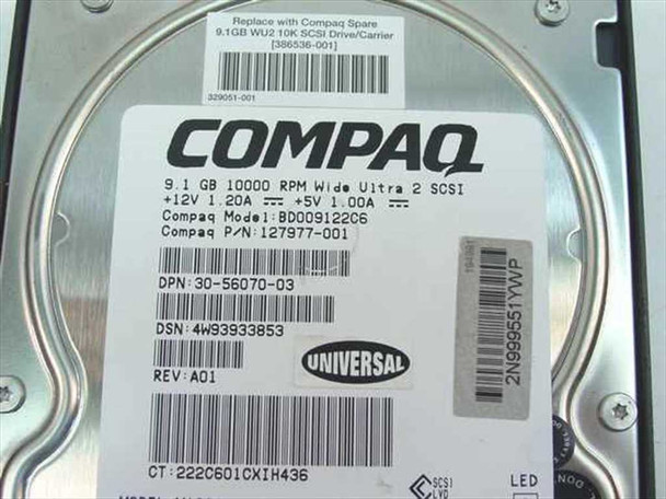 Compaq 127977-001 drive label close-up showing model BD009122C6, 9.1GB 10000 RPM Wide Ultra2 SCSI, +12V 1.20A +5V 1.00A, P/N 127977-001, REV A01
