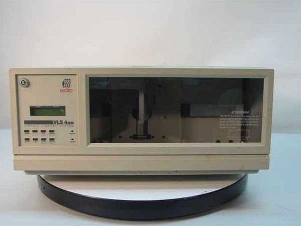 ADIC VLS 4MM tape backup autoloader front view showing LCD display, front panel controls, and robotic tape mechanism visible through smoked window