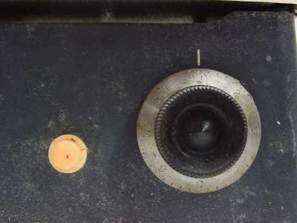 Corning PC-35 hot plate top view showing ceramic surface with heavy discoloration, temperature control knob with numbered dial, and cycle indicator light