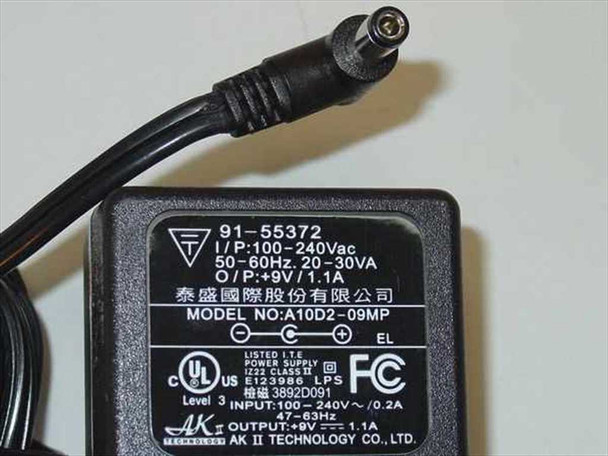 AK II Technology power supply model A10D2-09MP label showing 100–240V AC input and 9V 1.1A DC output specifications