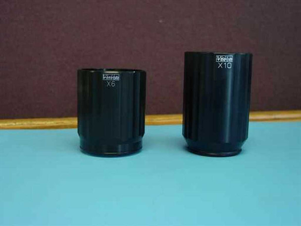 Vision Engineering Mantis 6x and 10x objective lenses side by side on blue surface — labeled X6 (left) and X10 (right)