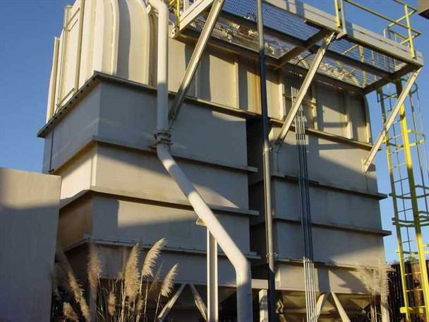 Multi-section large rooftop air handling unit with stacked filter/coil sections and yellow access ladder structure, exterior view
