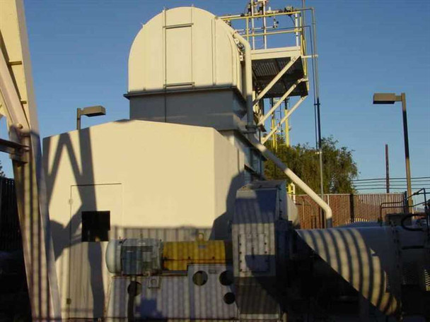 Large industrial HVAC air handler tower with cylindrical dome top and yellow piping structure, outdoor installation against blue sky