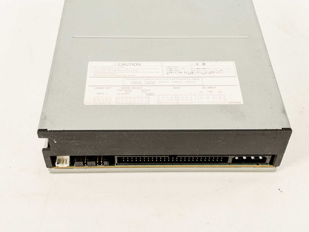 Toshiba XM-6201B 32x SCSI CD-ROM drive – bottom rear view showing caution label with audio out, SCSI, mode select, and DC input pinout diagrams
