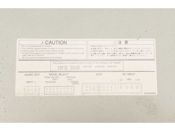 Toshiba XM-6201B caution label closeup – showing audio out, mode select, SCSI, and DC input connector diagrams