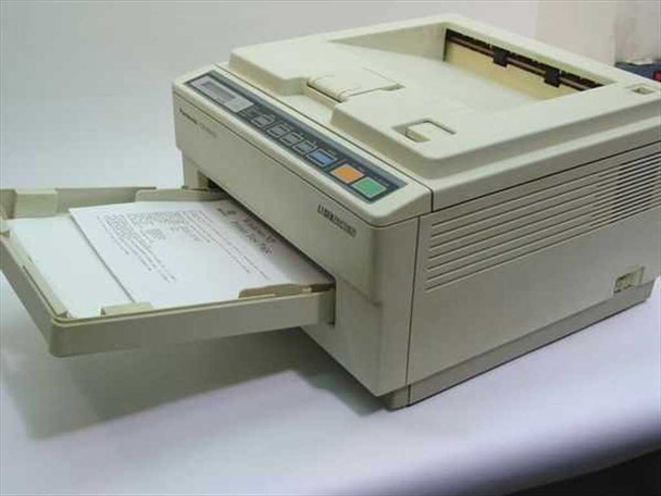 Panasonic KX-P4410 desktop laser printer — three-quarter front-left view with paper output tray extended and printed pages visible