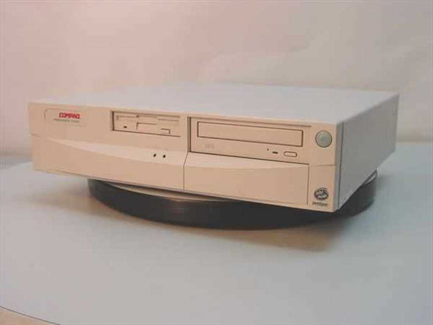 Compaq Presario 7222 desktop computer — front view showing Compaq logo badge, 3.5-inch floppy drive, CD-ROM drive, and slim desktop form factor on turntable stand