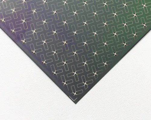 Close-up corner view of Nanosolar NanoCell CIGS solar cell surface showing metallic grid contact pattern and color gradient from green to purple