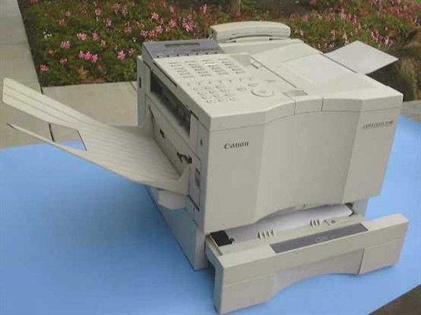 Canon Laser Class 5500 plain paper fax machine – right-side three-quarter view showing dual paper trays extended, ADF tray, and output tray