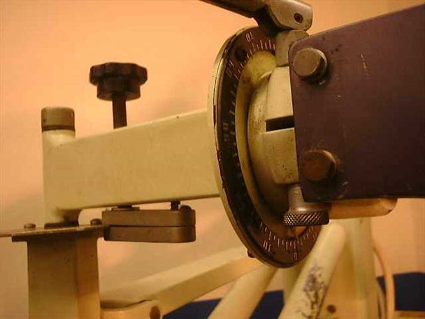 Keleket JD-AS x-ray tube arm — close-up of articulating pivot joint with degree-marked rotation collar, locking hardware, and adjustment knobs