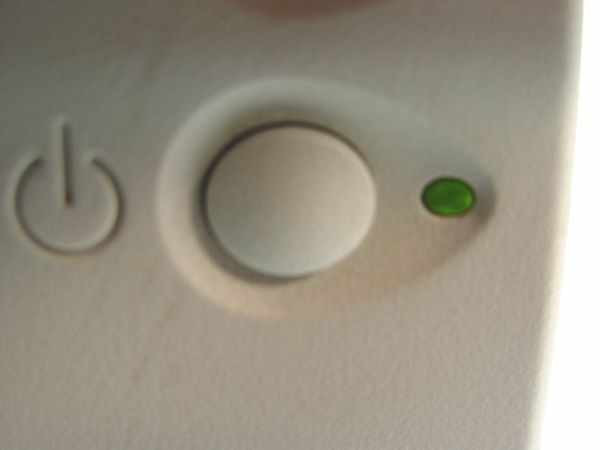 HP DeskJet 820Cse top panel close-up showing power button and green power indicator LED illuminated