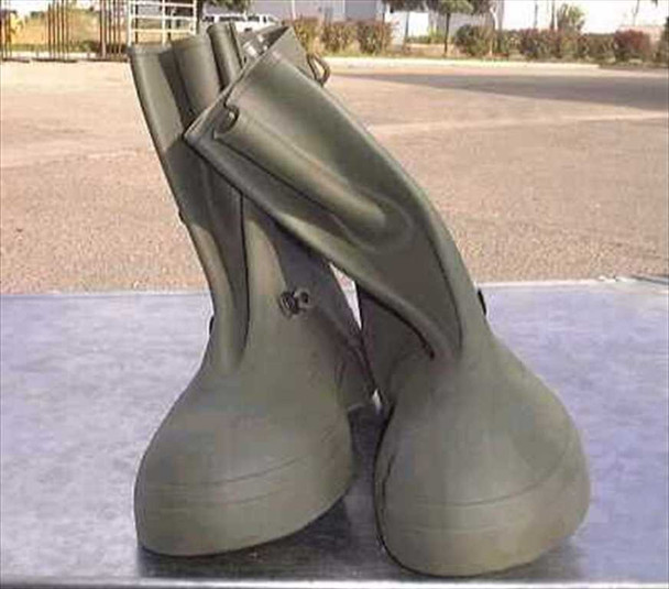 Military NBC chemical protective overboots Size 14 in olive drab rubber — pair shown standing upright outdoors on a surface, front and side view