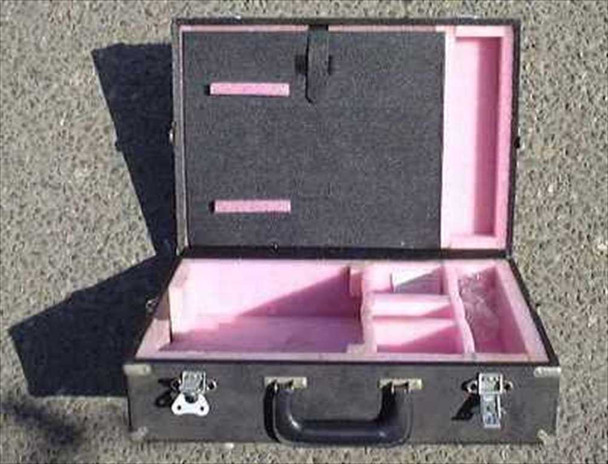 Eagle flight road case open showing pink foam-fitted interior with pre-cut compartments, lid fitted with black foam strips, and two butterfly latches on front