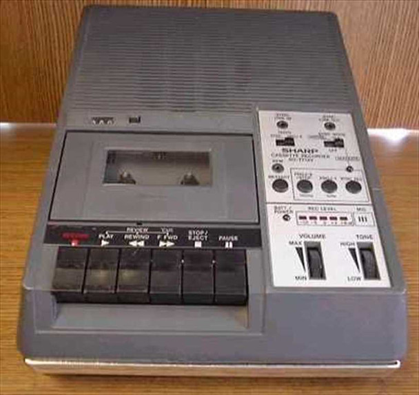 Sharp RD-771AV cassette recorder — top view showing cassette bay, transport buttons, volume and tone sliders, and right-side control panel
