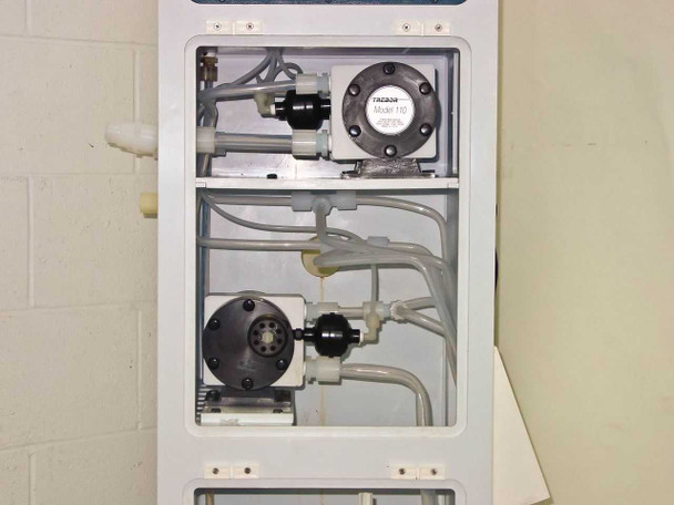 Interior pump compartment showing Trebor Model 110 pump and polypropylene pump assembly with tubing