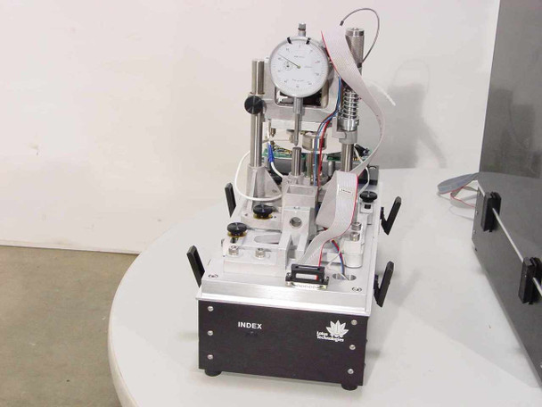 Lotus Technologies 7100 CSS tester module – single unit removed from enclosure showing dial indicator, 3-axis micro-gaging assembly, pneumatic components, and wiring