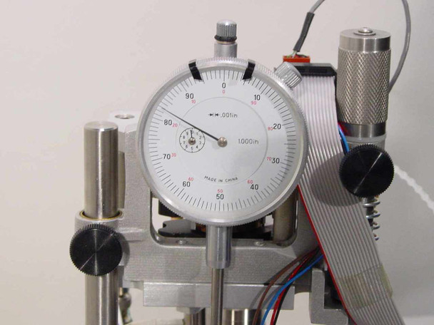 Lotus Technologies 7100 CSS module – close-up of dial indicator face graduated in 0.0001 inch increments, made in China, mounted on micro-gaging assembly