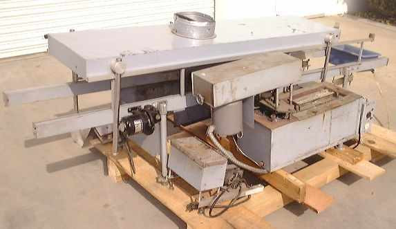 Technical Devices Mark I-C wave soldering machine – opposite side view showing drive motor assembly, solder pot section, and flux collection tray