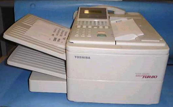 Toshiba TF651 Turbo plain paper fax machine — front/side view showing paper trays, control panel with keypad and LCD display, and Toshiba Turbo branding on the right side
