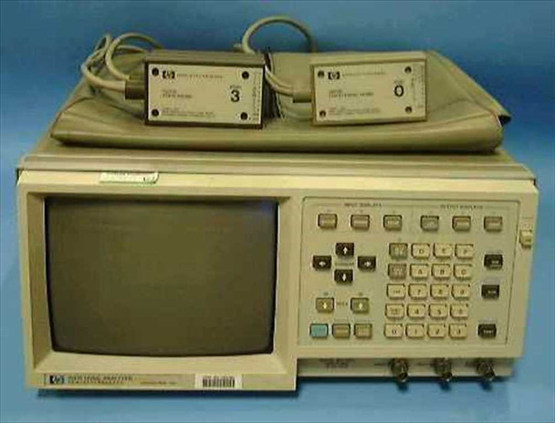 HP 1631D Logic Analyzer front view showing CRT display, front-panel keypad, and two HP probe pods resting on top