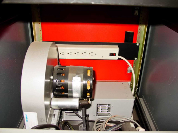 Interior base compartment detail showing Kooltronic KBB63 blower motor assembly and multi-outlet power strip mounted inside cabinet